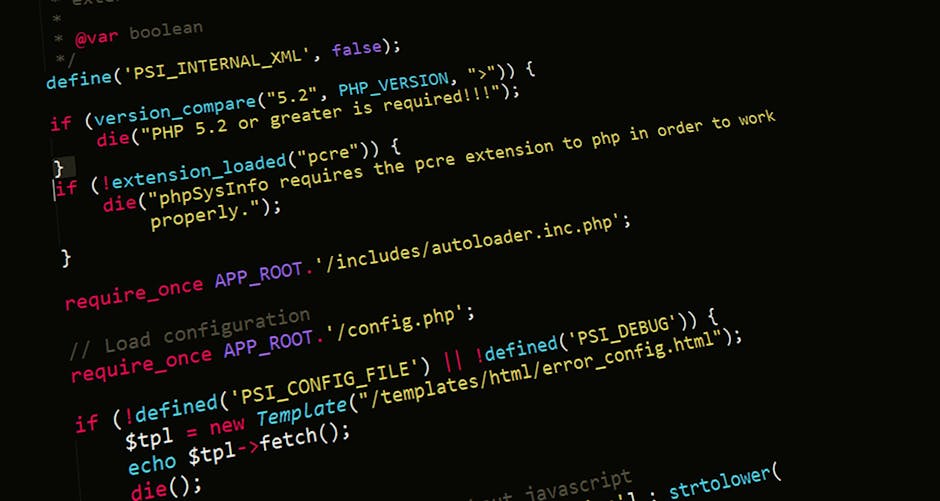 The image displays a close-up of a computer screen with blurred, partially visible text and code, including HTML tags and CSS elements in various colors such as blue, purple, red, and black, on a ligh